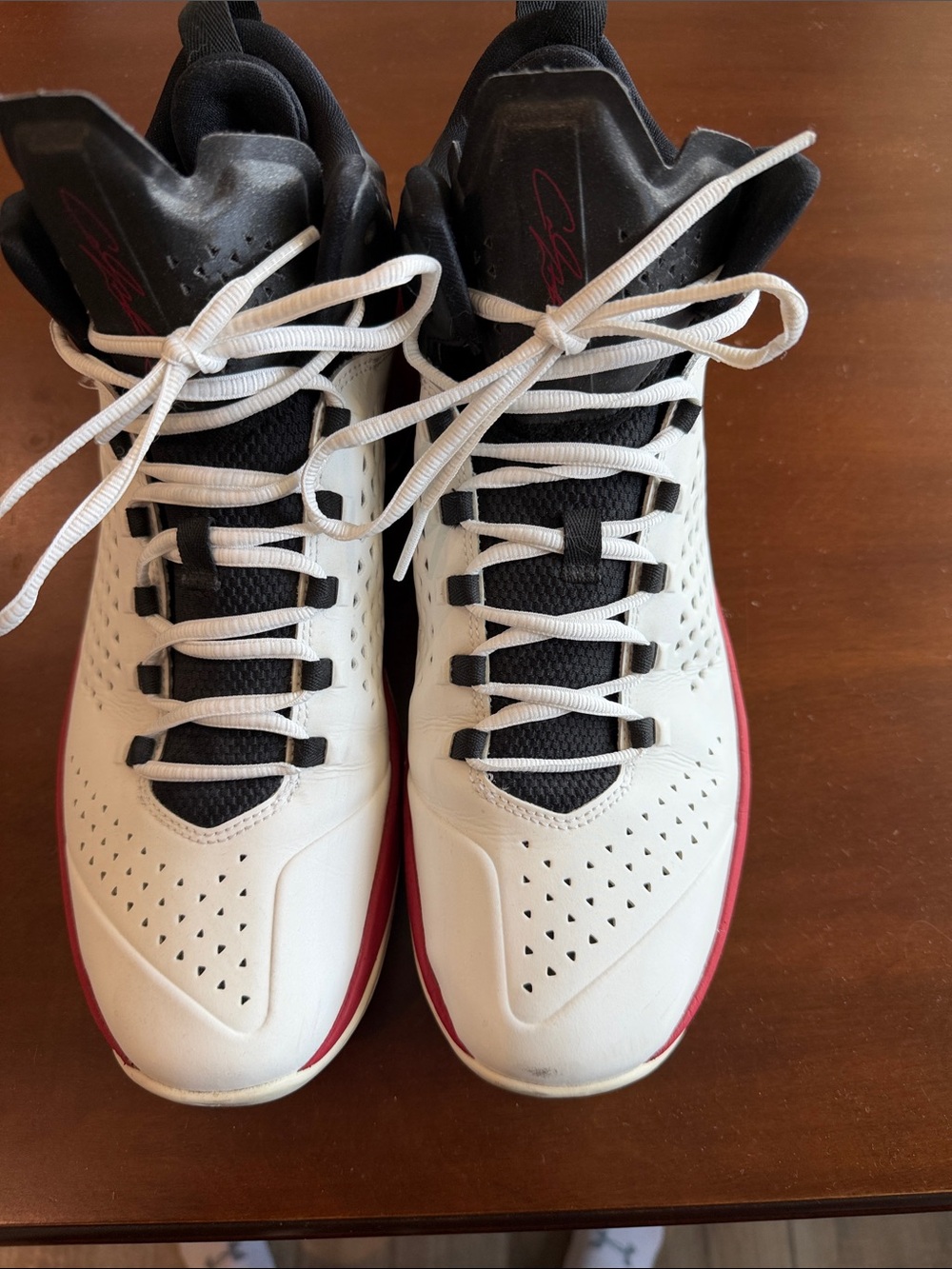 Nike Air Jordan Melo M11 basketball shoes in a white, black  gym red colorway.
